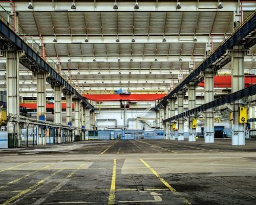Expansive industrial warehouse interior showcasing steel framework and spacious layout for diverse manufacturing needs.